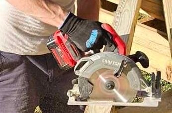 Stu cutting pressure-treated lumber with a circular saw while building a wooden deck in Central Virginia.